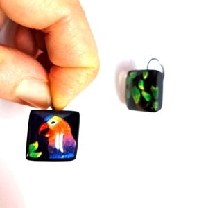 Mismatched parrot and leaves earrings